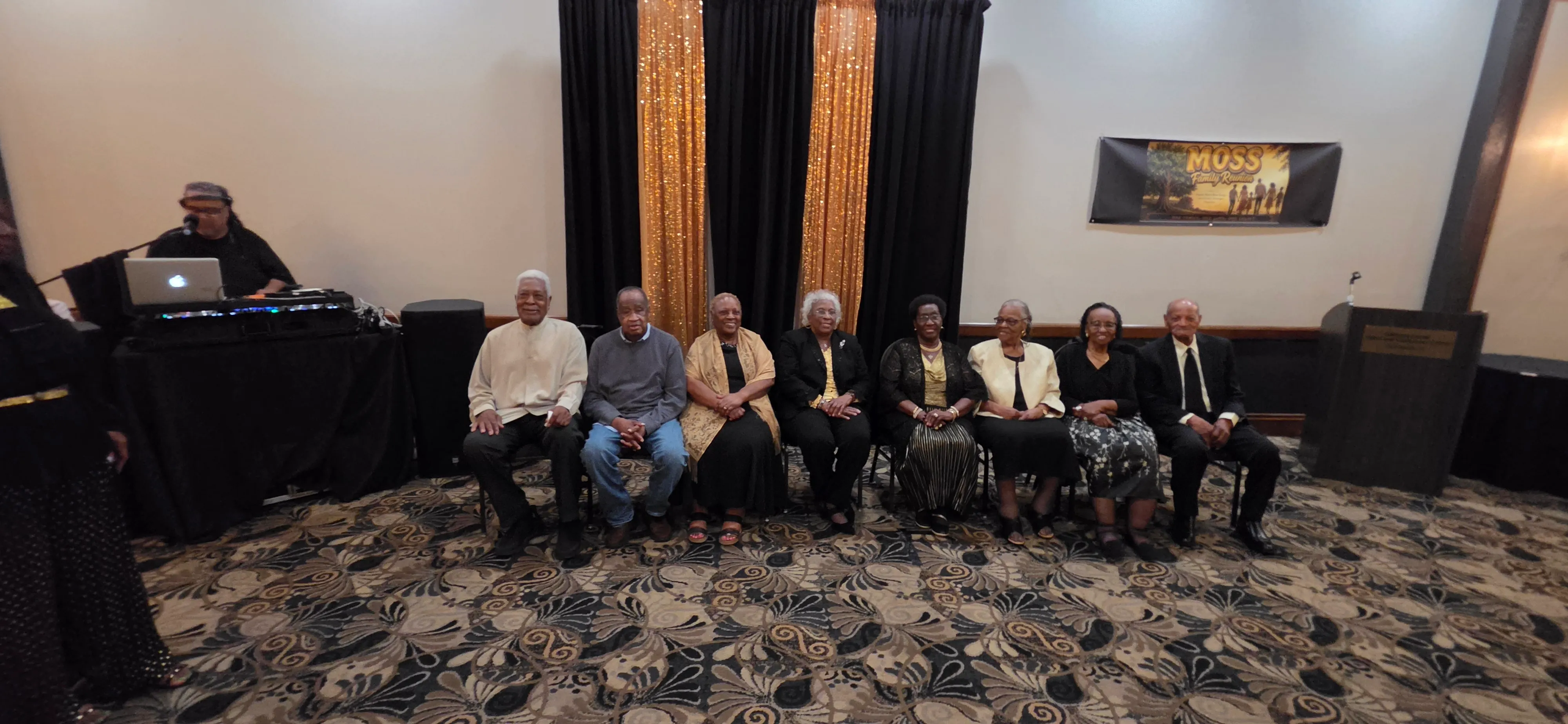 A row of elders seated together in the banquet hall.